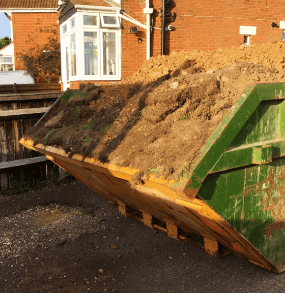 Close up of a skip full of soil and garden waste